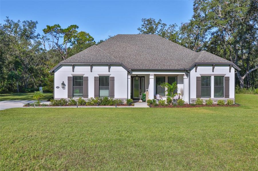 Front exterior of a new home in Bella Terra, Hudson, FL, highlighting curb appeal (Image 21).