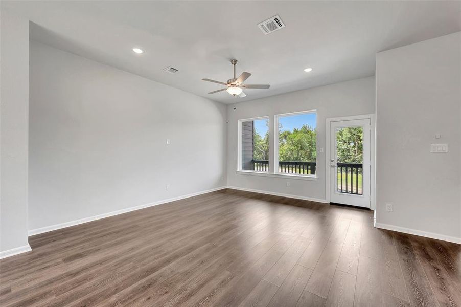 Spacious interior featuring wood-finish flooring, recessed lighting, and a ceiling fan