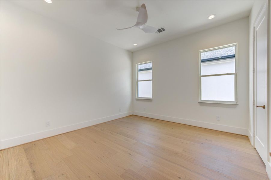 Rich French Oak flooring flows seamlessly throughout each bedroom and the upstairs living spaces, creating a cohesive sense of warmth and sophistication.
