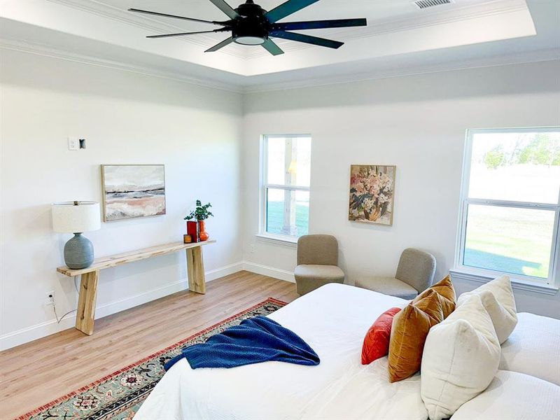 Bedroom featuring multiple windows, ceiling fan, and ornamental molding