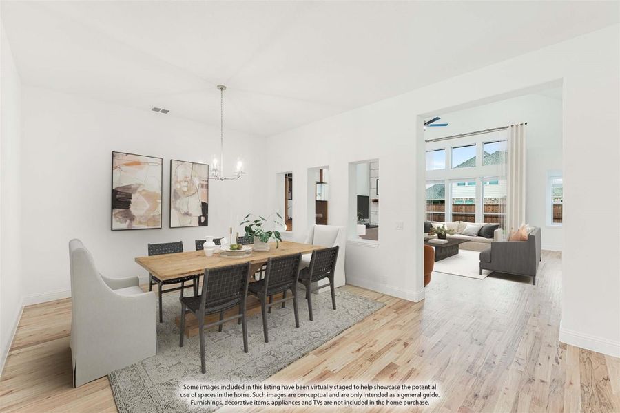 Dining room with wood table, six chairs, chandelier, and light hardwood floors open to living room