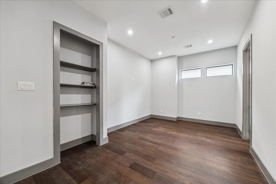 Flexible upstairs space offers endless possibilities, from a media room or playroom to a quiet home office, complete with custom built-in shelves and natural light from dual windows. Flexible upstairs space offers endless possibilities, from a media room or playroom to a quiet home office, complete with custom built-in shelves and natural light from dual windows.