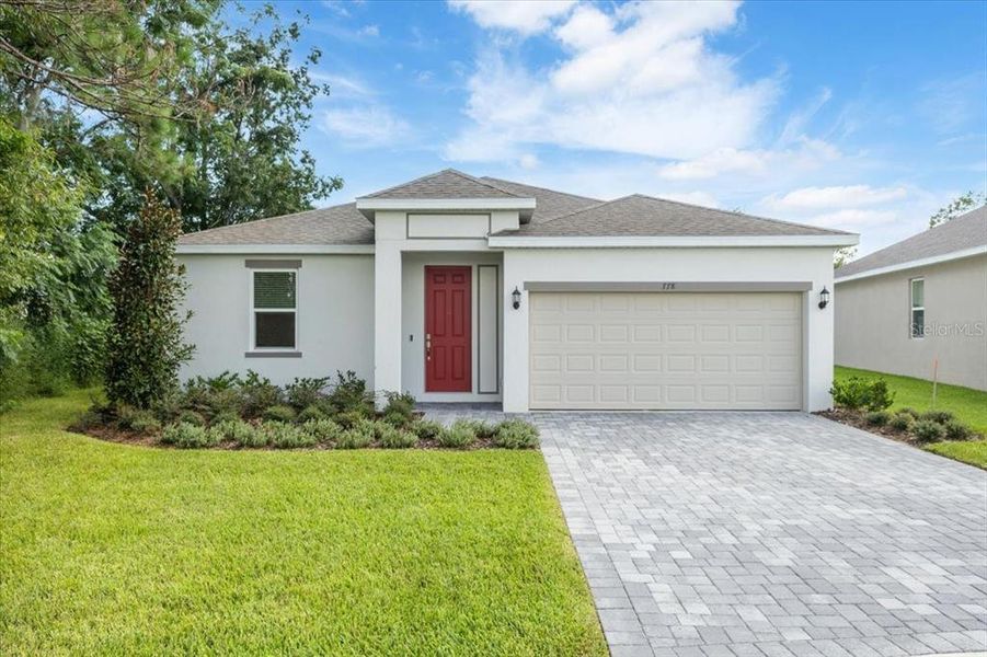 Front exterior of a new home in Mirror Lake Village, Fruitland Park, FL, highlighting curb appeal (Image 1).