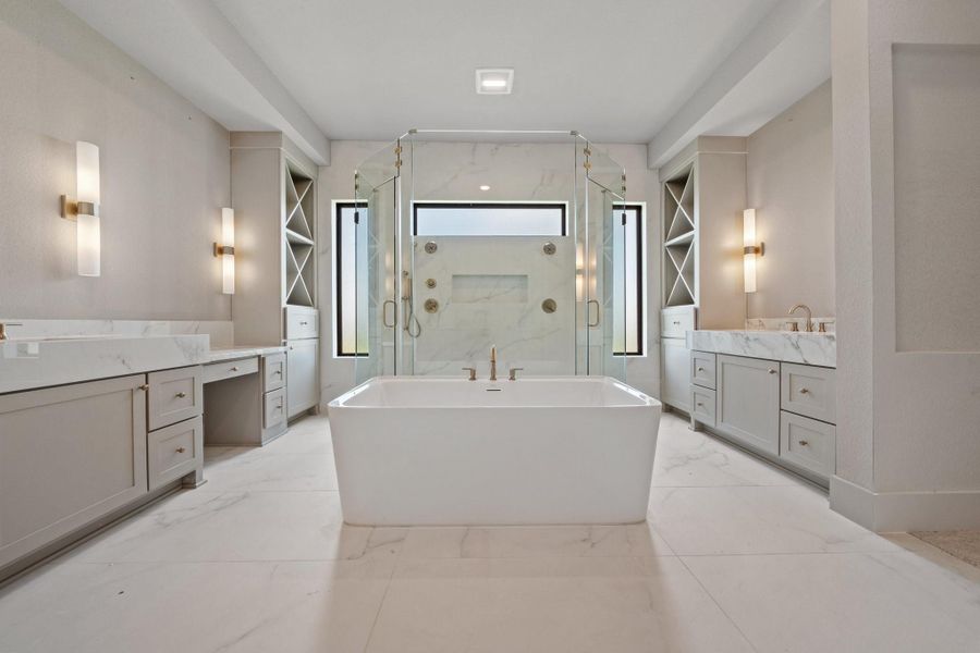 Retreat to a spa-like main bathroom with a freestanding tub and dual showerheads for the ultimate in relaxation. Retreat to a spa-like main bathroom with a freestanding tub and dual showerheads for the ultimate in relaxation.
