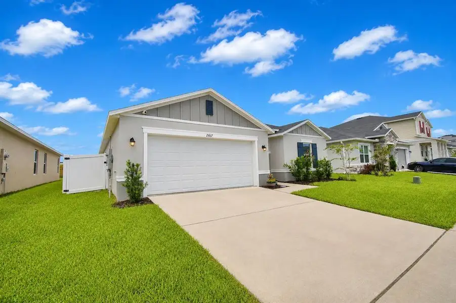 Front exterior of a new home in , Haines City, FL, highlighting curb appeal (Image 1). Front exterior of a new home in , Haines City, FL, highlighting curb appeal (Image 1).