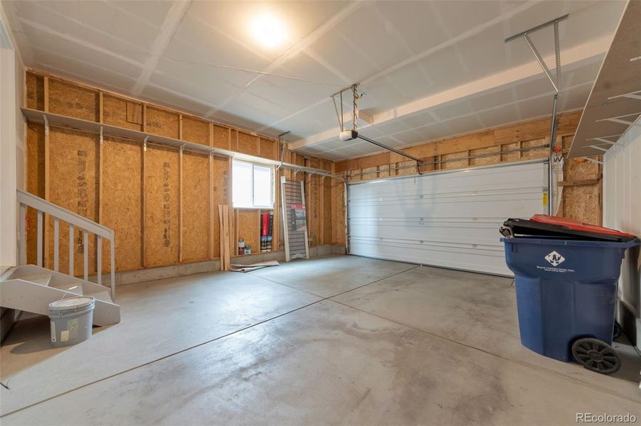 Large garage with high ceiling, extra storage and workspace!