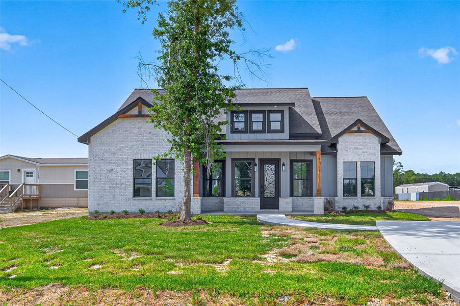 Front exterior of a new home in , Huffman, TX, highlighting curb appeal (Image 1). Front exterior of a new home in , Huffman, TX, highlighting curb appeal (Image 1).