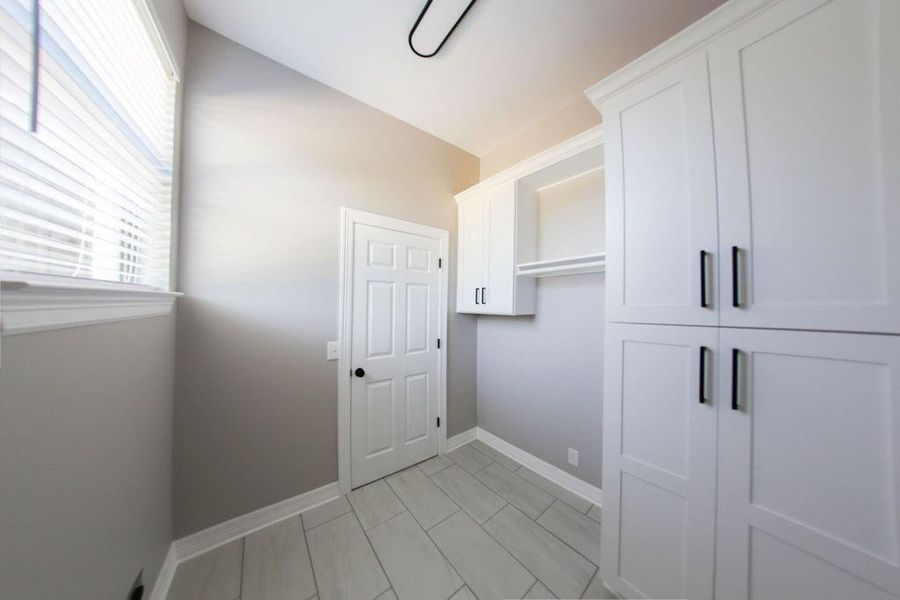 Laundry room featuring baseboards Laundry room featuring baseboards