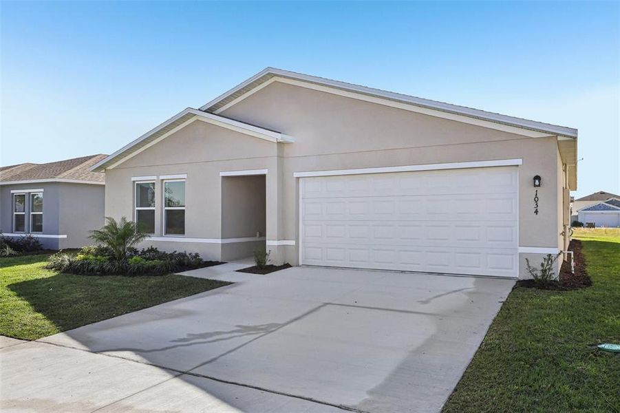 Front exterior of a new home in The Collection at Bradbury Creek, Haines City, FL, highlighting curb appeal (Image 1).