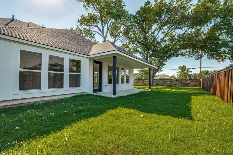 Fenced backyard with a patio area