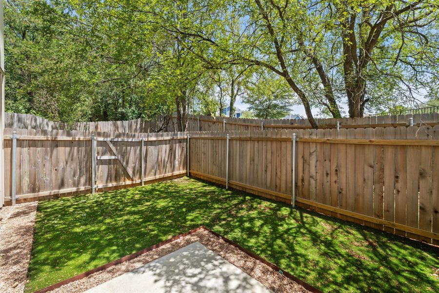 Fenced backyard with a patio area Fenced backyard with a patio area