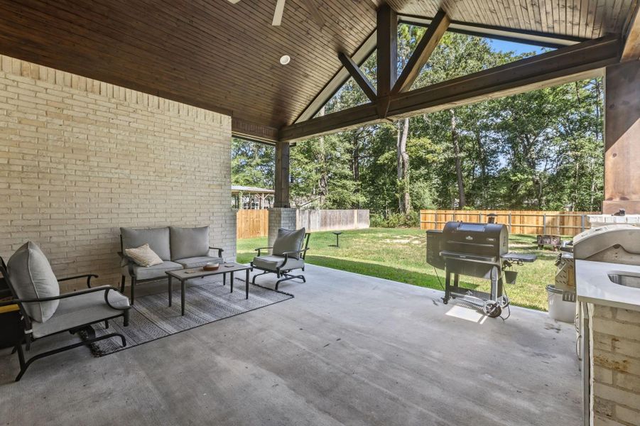 OUTDOOR LIVING — Generous covered outdoor living area overlooks the backyard, offering a seamless setting for year-round indoor-outdoor entertaining.
