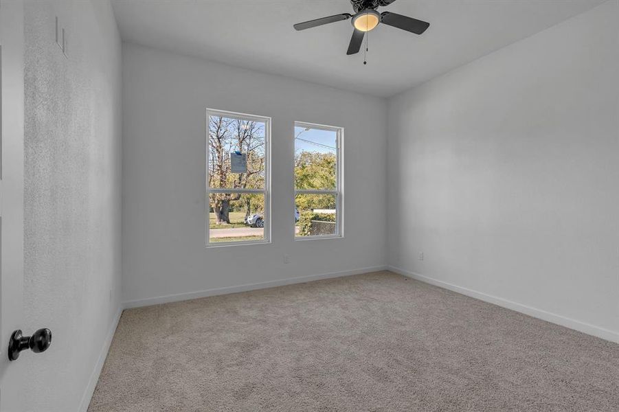 Spare room with ceiling fan and carpet