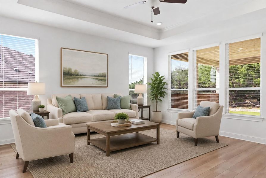 Virtually staged. A naturally illuminated living room features gleaming hardwood floors and high tray ceilings with recessed lighting. Virtually staged. A naturally illuminated living room features gleaming hardwood floors and high tray ceilings with recessed lighting.