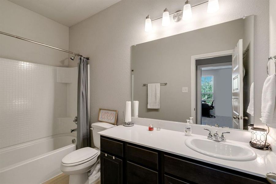 Full bathroom with vanity, toilet, and shower / bath combo