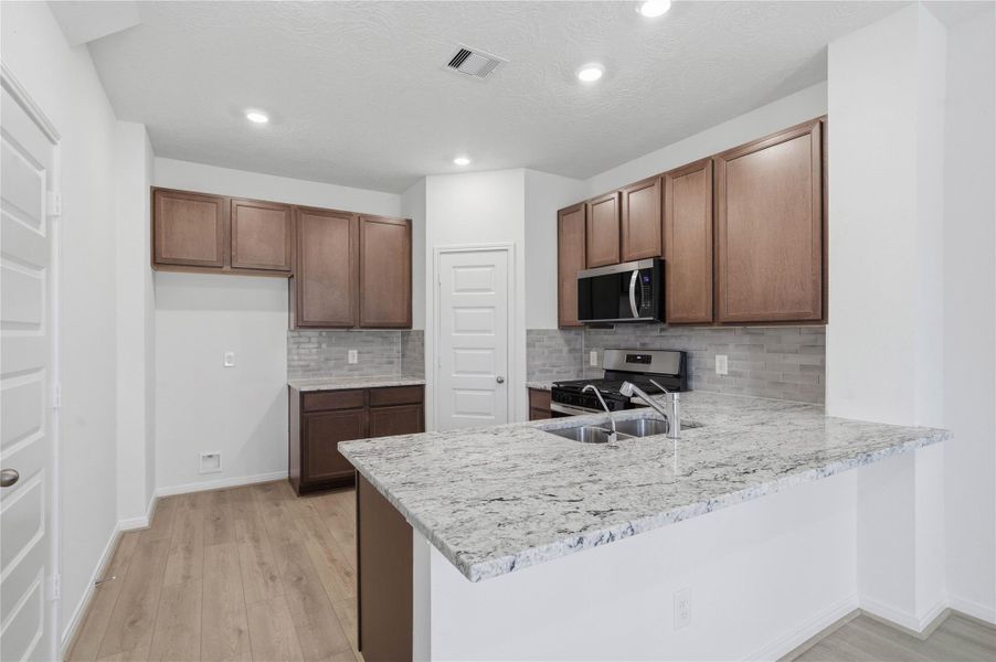This spacious kitchen has it all—ample storage, generous counter space, and a layout that truly makes it the heart of the home. This spacious kitchen has it all—ample storage, generous counter space, and a layout that truly makes it the heart of the home.