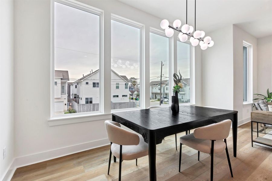 It is bathed in natural light from the adjacent glass window, offering a stunning view of the neighborhood – perfect for enjoying meals with a scenic backdrop. It is bathed in natural light from the adjacent glass window, offering a stunning view of the neighborhood – perfect for enjoying meals with a scenic backdrop.