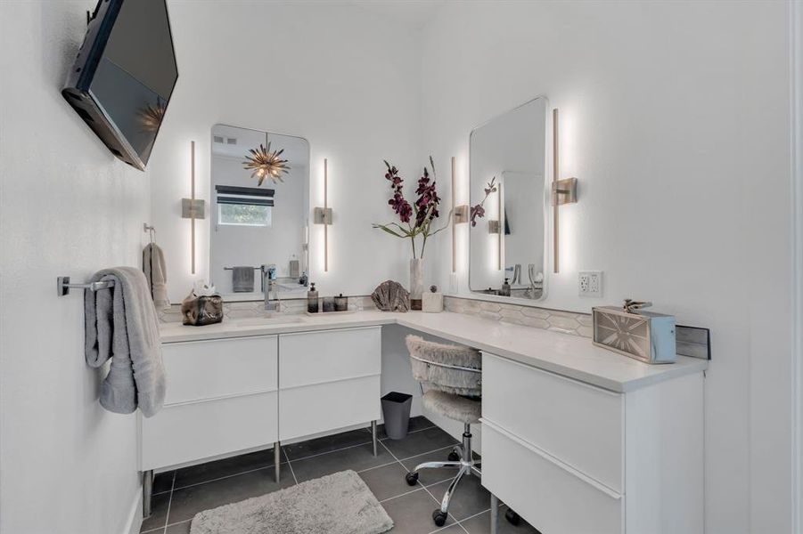 Bathroom featuring vanity and dark tile patterned flooring