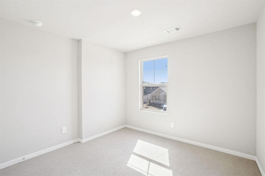 Carpeted empty room featuring baseboards and recessed lighting Carpeted empty room featuring baseboards and recessed lighting