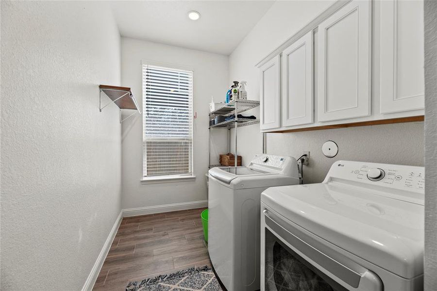 Even the chores feel luxurious in this home! Step into the utility room and experience its amazing feel – with space for a full-sized fridge or freezer, plus ample overhead cabinet space, making laundry day a breeze.