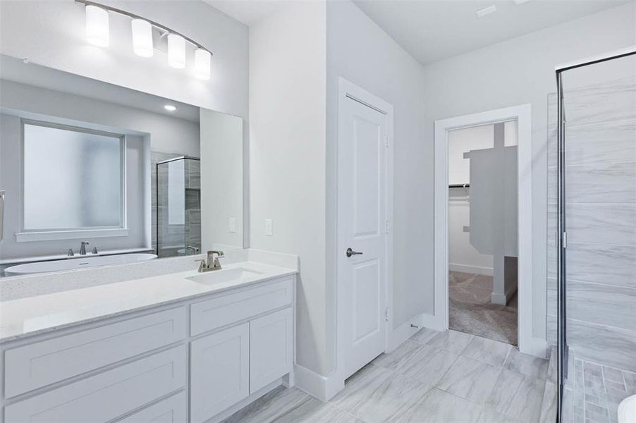 Primary bathroom featuring a soaking tub, separate walk-in shower, and bright neutral finishes.