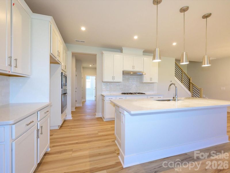 Gourmet kitchen with white quartz countertop