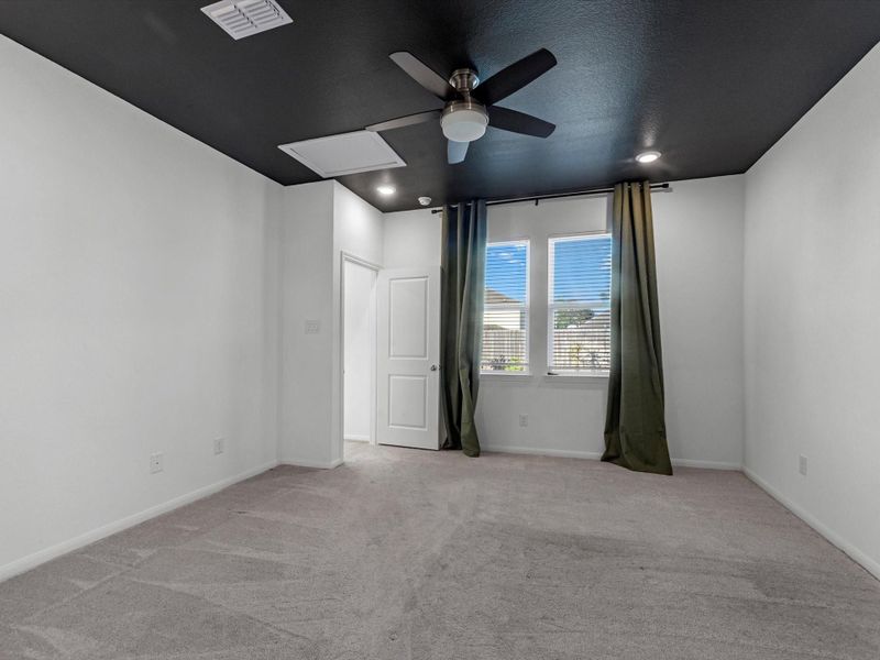 Another view of primary suite that overlooks back yard