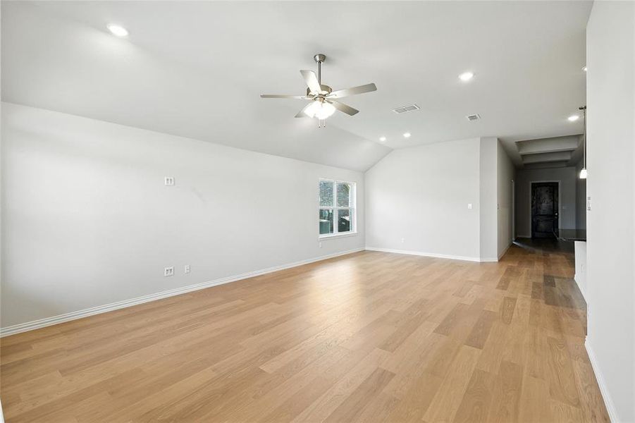 Unfurnished living room featuring a ceiling fan, vaulted ceiling, light wood-type flooring, and recessed lighting Unfurnished living room featuring a ceiling fan, vaulted ceiling, light wood-type flooring, and recessed lighting