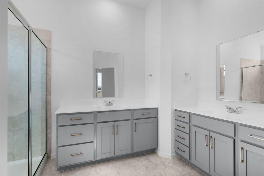 Bathroom featuring a stall shower and two vanities Bathroom featuring a stall shower and two vanities