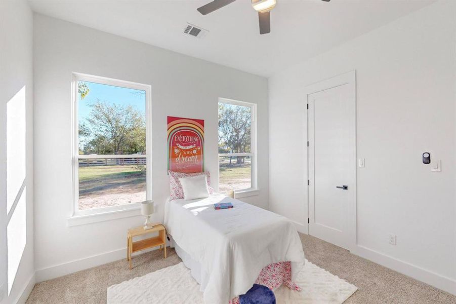 Bedroom featuring light carpet and ceiling fan