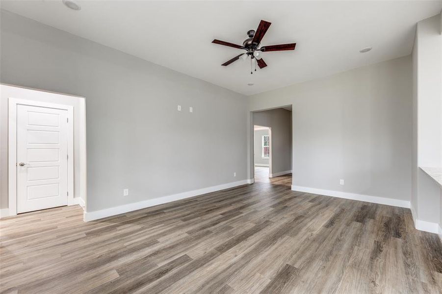 Unfurnished living room featuring a ceiling fan, recessed lighting, and light wood-type flooring