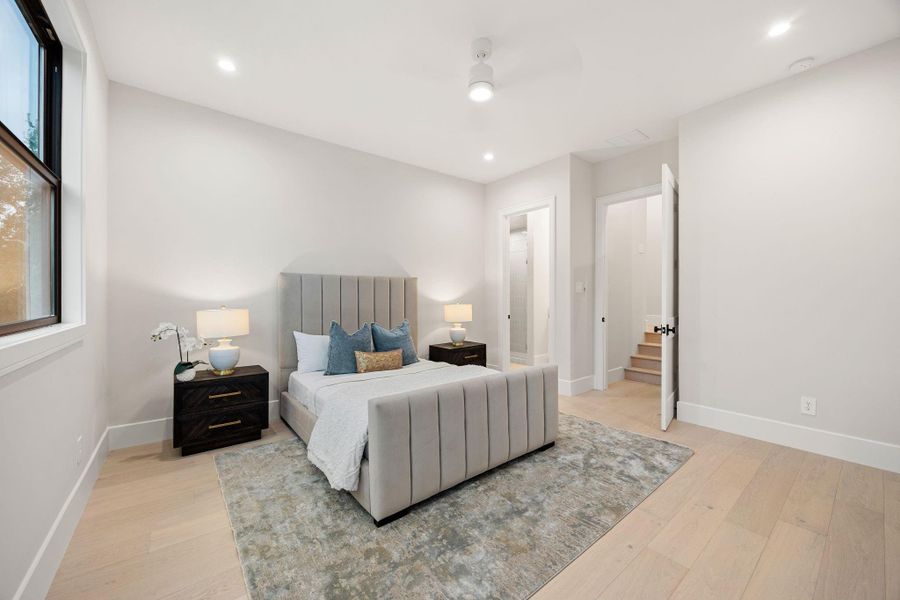 A well-appointed bedroom offering comfort and simplicity, with a calming color palette and abundant natural light. The layout is thoughtfully designed for both relaxation and functionality. The highlight of this space is the direct access to a private bath, providing added convenience and creating a cohesive, suite-like living experience.