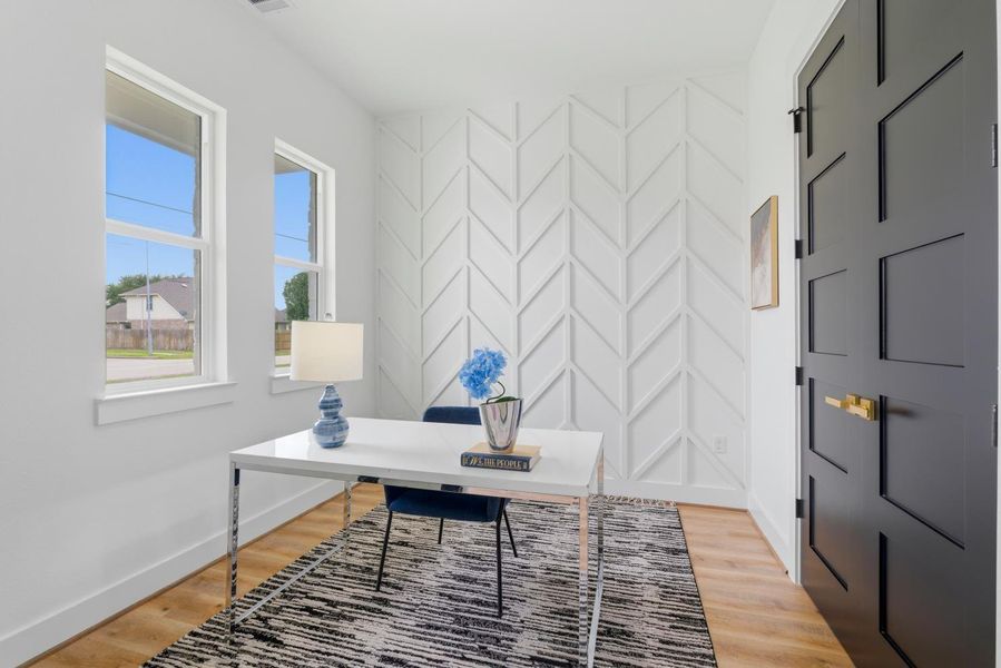 Inside, a dedicated office features stylish accent walls and a matching set of double doors to the right that open to a convenient closet, keeping the workspace organized and sleek.