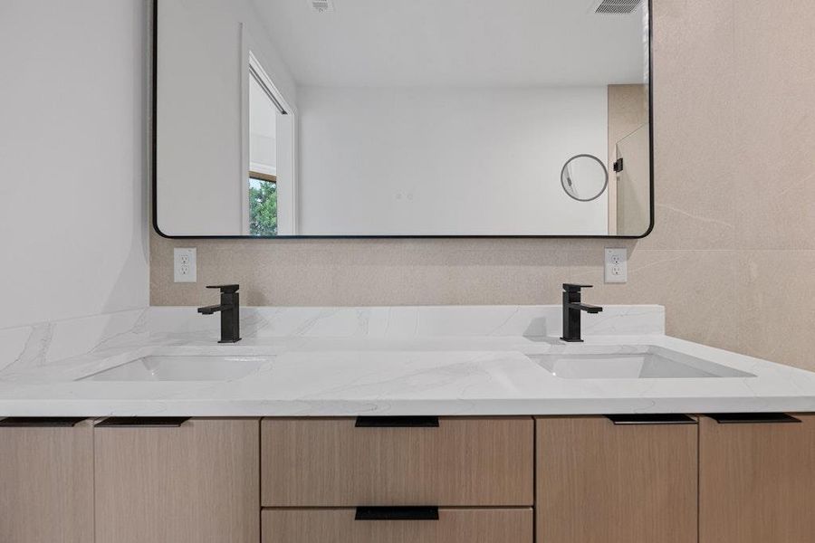 Full bath featuring double vanity