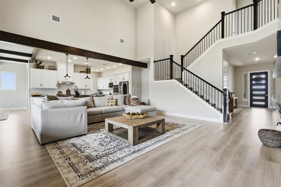 Ceiling Beams And An Attractive Staircase Accent This Area.