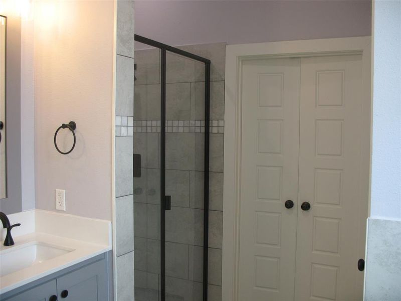 Bathroom with vanity and a stall shower
