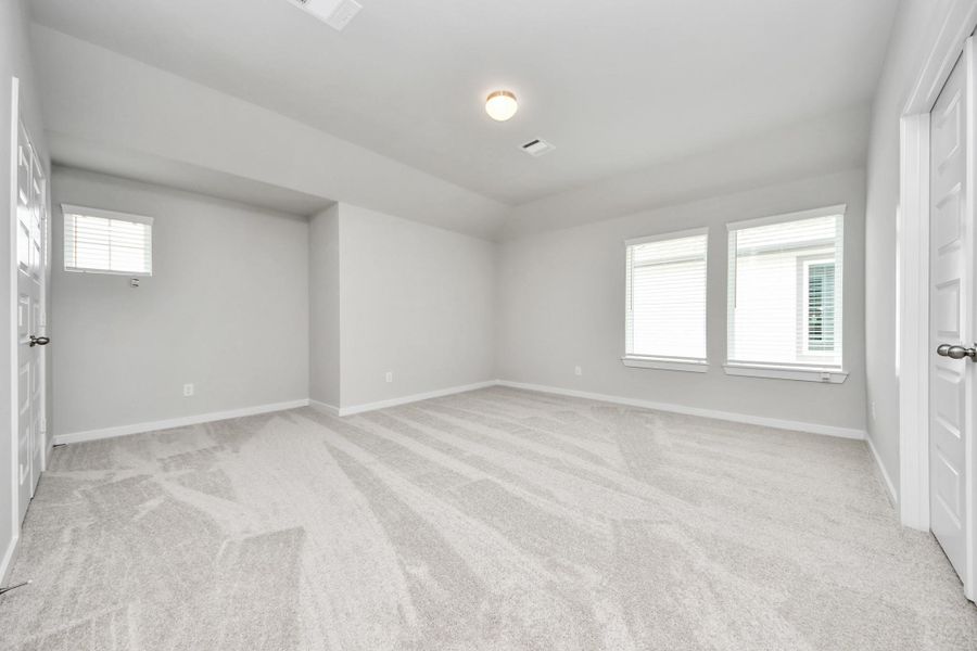 Ascend to relaxation in this fantastic game room! Ideal for both casual gatherings and adult gaming, it boasts plush carpet, lofty ceilings, custom paint, and ample windows for abundant natural light. Sample photo of completed home with similar floor plan. Actual colors and selections may vary.