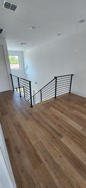 Staircase with hardwood / wood-style floors