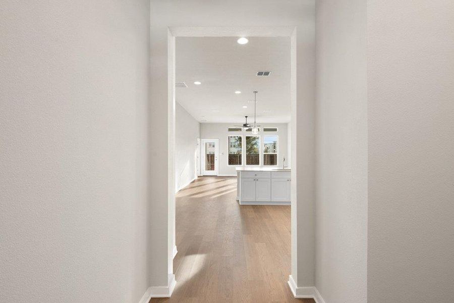Corridor with recessed lighting and light wood finished floors