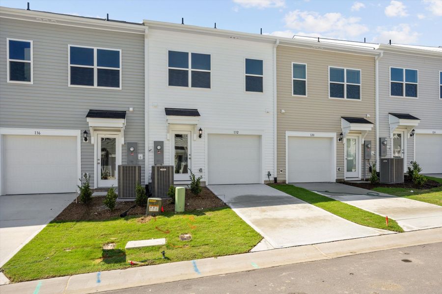 Front exterior of a new home in Renaissance at White Oak, Garner, NC, highlighting curb appeal (Image 2). Front exterior of a new home in Renaissance at White Oak, Garner, NC, highlighting curb appeal (Image 2).