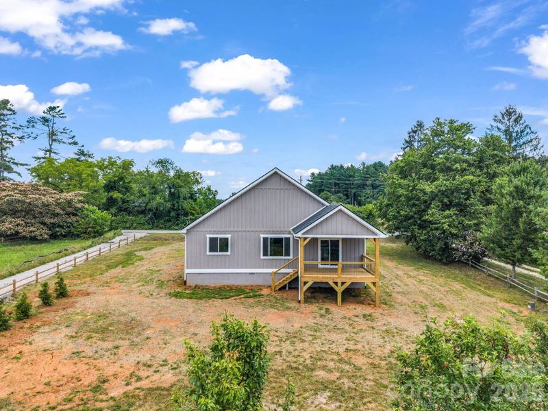 View of the back of the home, covered rear porch with fan, great entertainment floor plan and useable flat outdoor space View of the back of the home, covered rear porch with fan, great entertainment floor plan and useable flat outdoor space