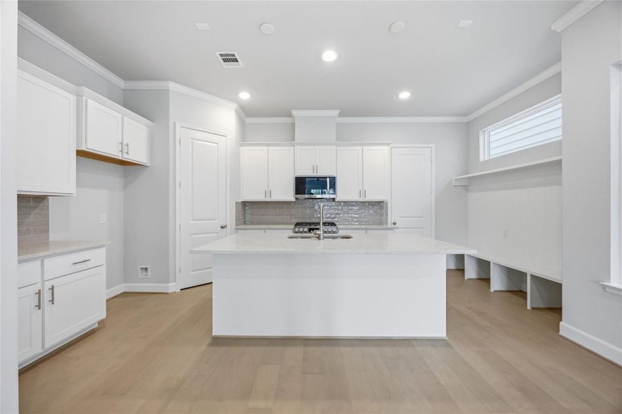 Culinary Paradise: A chef's dream kitchen awaits, featuring direct garage access for seamless transitions from car to culinary creation.