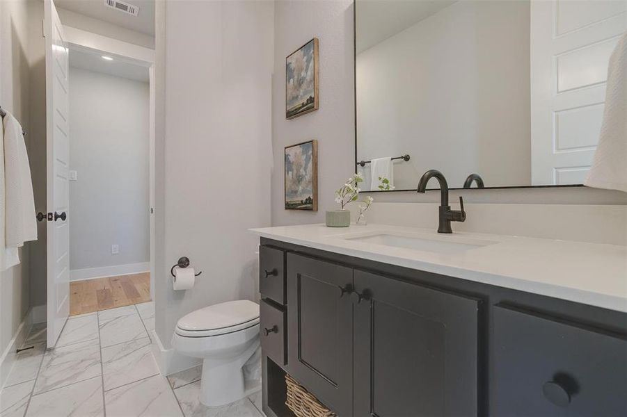 Bathroom featuring vanity and toilet