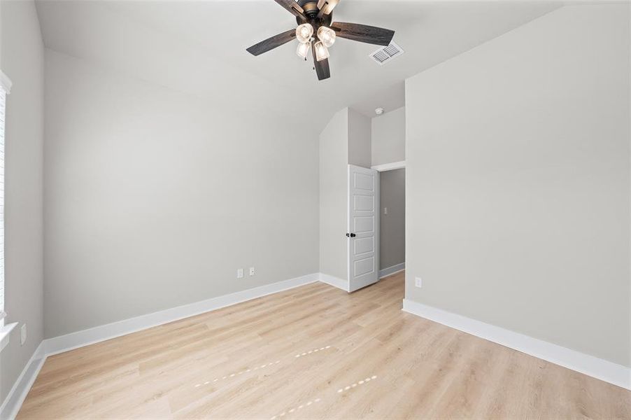 Empty room featuring light wood-type flooring and ceiling fan Empty room featuring light wood-type flooring and ceiling fan