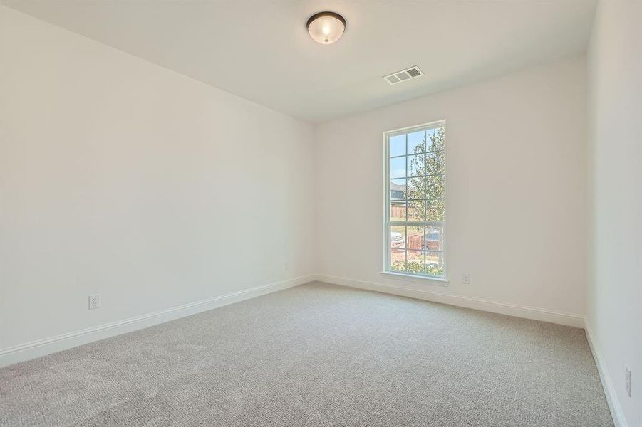 Unfurnished room with light carpet and a wealth of natural light