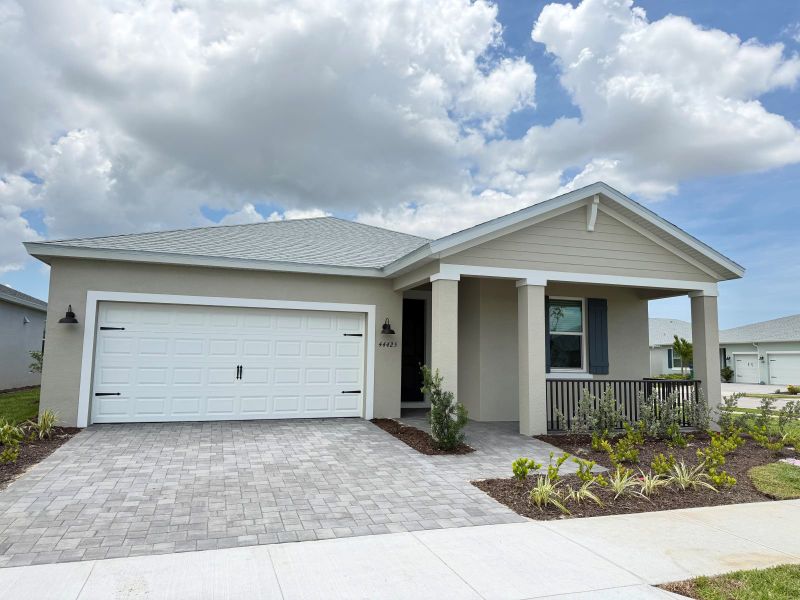 Front exterior of a new home in Crescent Lakes - Reserve Series, Punta Gorda, FL, highlighting curb appeal (Image 2). Front exterior of a new home in Crescent Lakes - Reserve Series, Punta Gorda, FL, highlighting curb appeal (Image 2).