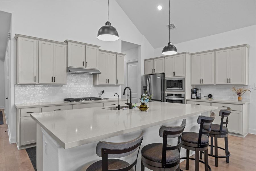 Culinary delights await in this modern kitchen with ample counter space and soaring vaulted ceilings. Culinary delights await in this modern kitchen with ample counter space and soaring vaulted ceilings.
