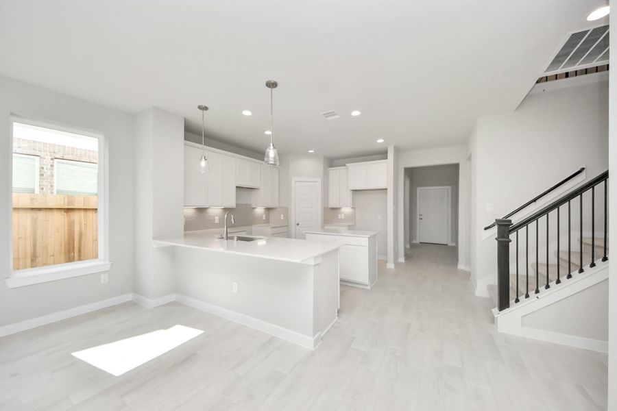 Step into the dream kitchen you've always wanted! This generously spacious culinary haven features a massive granite island, high ceilings, soft-close cabinets, granite countertops, stainless steel appliances, a sleek tile backsplash, and recessed lighting. Step into the dream kitchen you've always wanted! This generously spacious culinary haven features a massive granite island, high ceilings, soft-close cabinets, granite countertops, stainless steel appliances, a sleek tile backsplash, and recessed lighting.