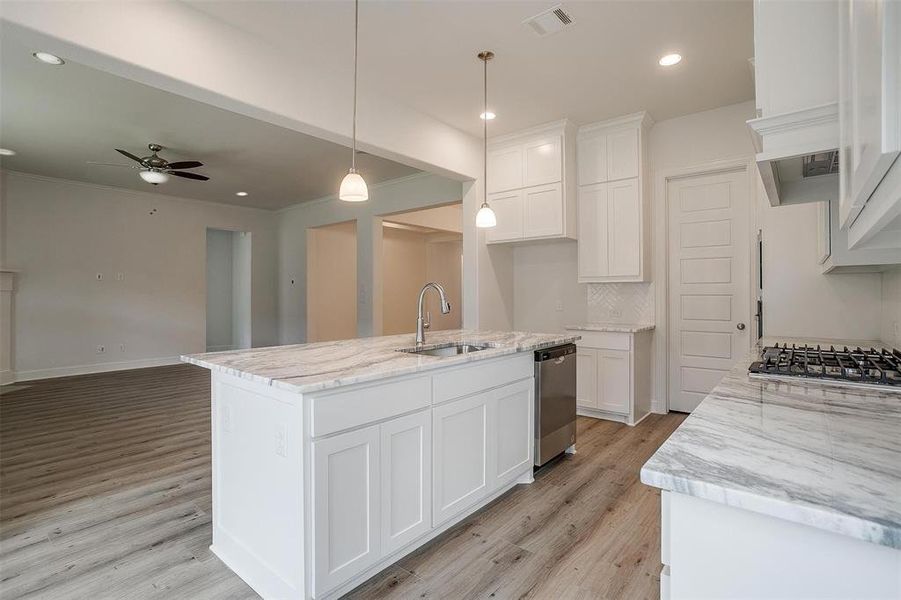 Kitchen featuring sink, ceiling fan, stainless steel appliances, and light hardwood / wood-style floors