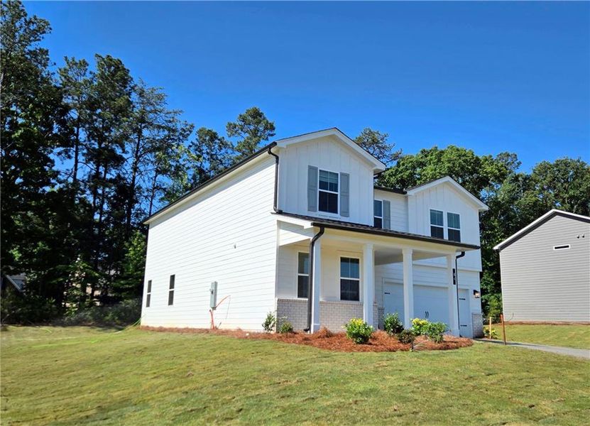 Front exterior of a new home in Hawthorne Reserve, Dallas, GA, highlighting curb appeal (Image 1). Front exterior of a new home in Hawthorne Reserve, Dallas, GA, highlighting curb appeal (Image 1).